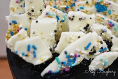 Chocolate Cake with Dark Cocoa Swiss Meringue Buttercream. Topped with White Chocolate Barks