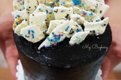 Chocolate Cake with Dark Cocoa Swiss Meringue Buttercream. Topped with White Chocolate Barks