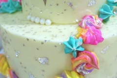 Two Tiers of Carrot Cake. Filled and Covered with Cream Cheese Frosting. Decorated with some Meringue Cookies.