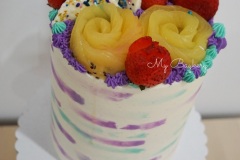 Vanilla Layer Cakes with Fresh Strawberries and Golden Kiwis between each layers. Covered with Vanilla Swiss Meringue Buttercream. Decorated with fresh fruits and homemade White Chocolate Barks.